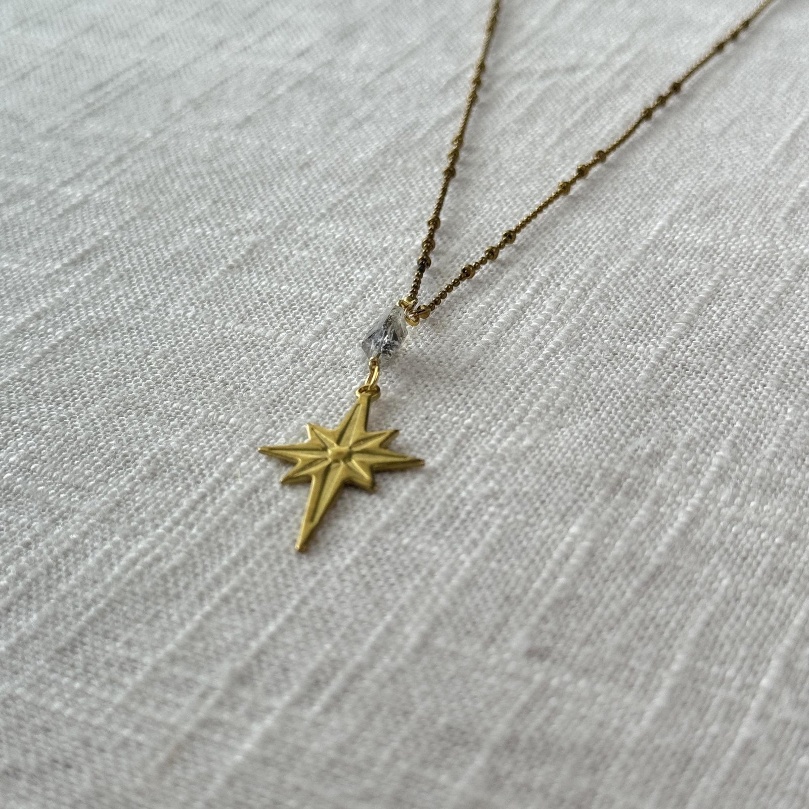 The Spellcrafter Herkimer Diamond North Star Necklace, featuring an eight-pointed star pendant and sparkling...