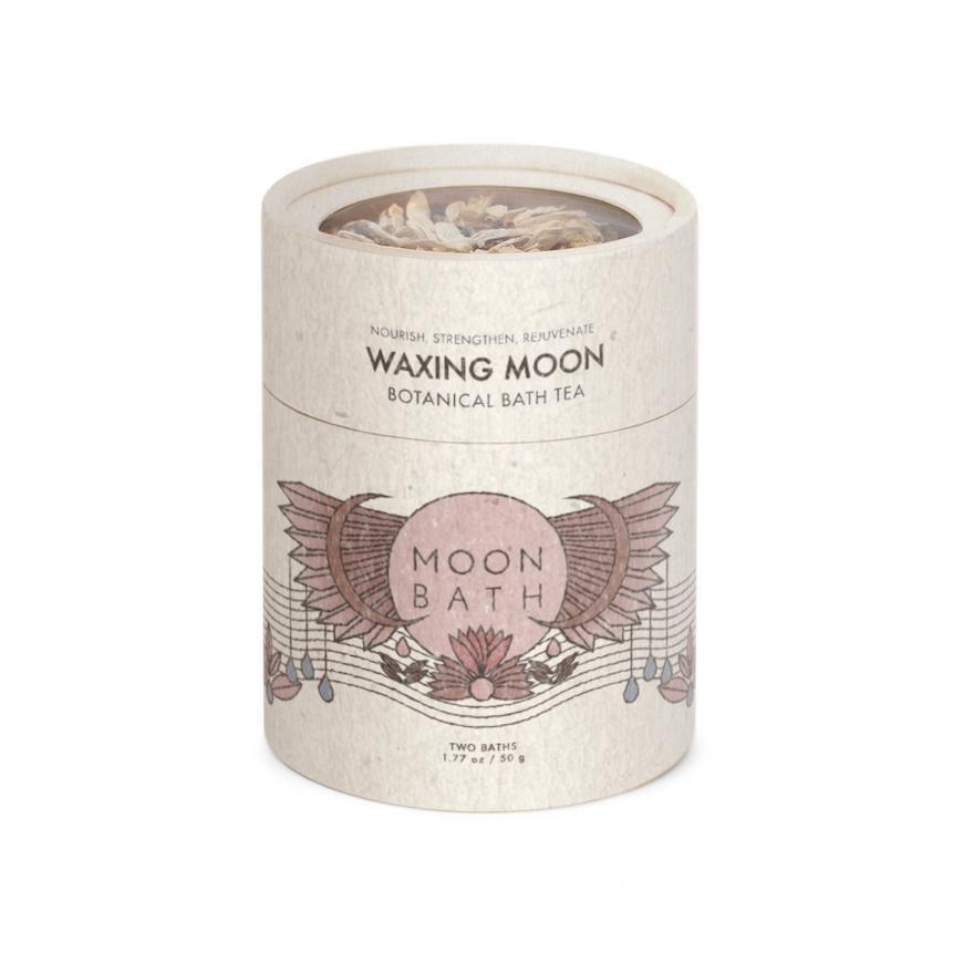 A cylindrical container labeled Waxing Moon Bath Tea by Spellcrafter, with pink and brown geometric floral illustrations, contains two baths (57g/2oz).