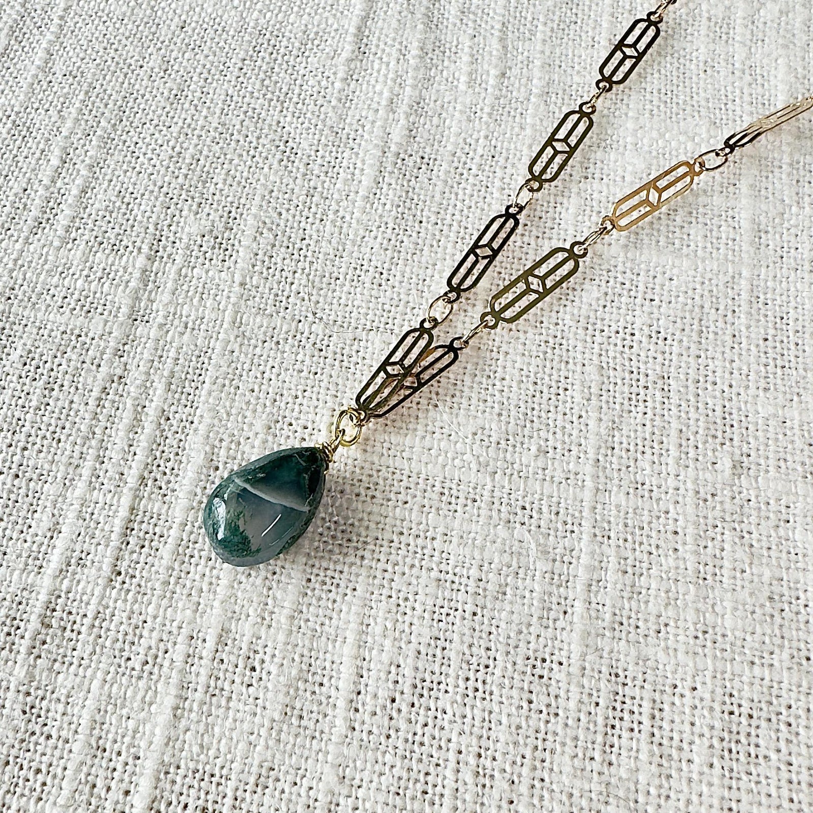 The Spellcrafter Moss Agate Chain Necklace features gold-plated, geometric links and a teardrop-shaped Moss...