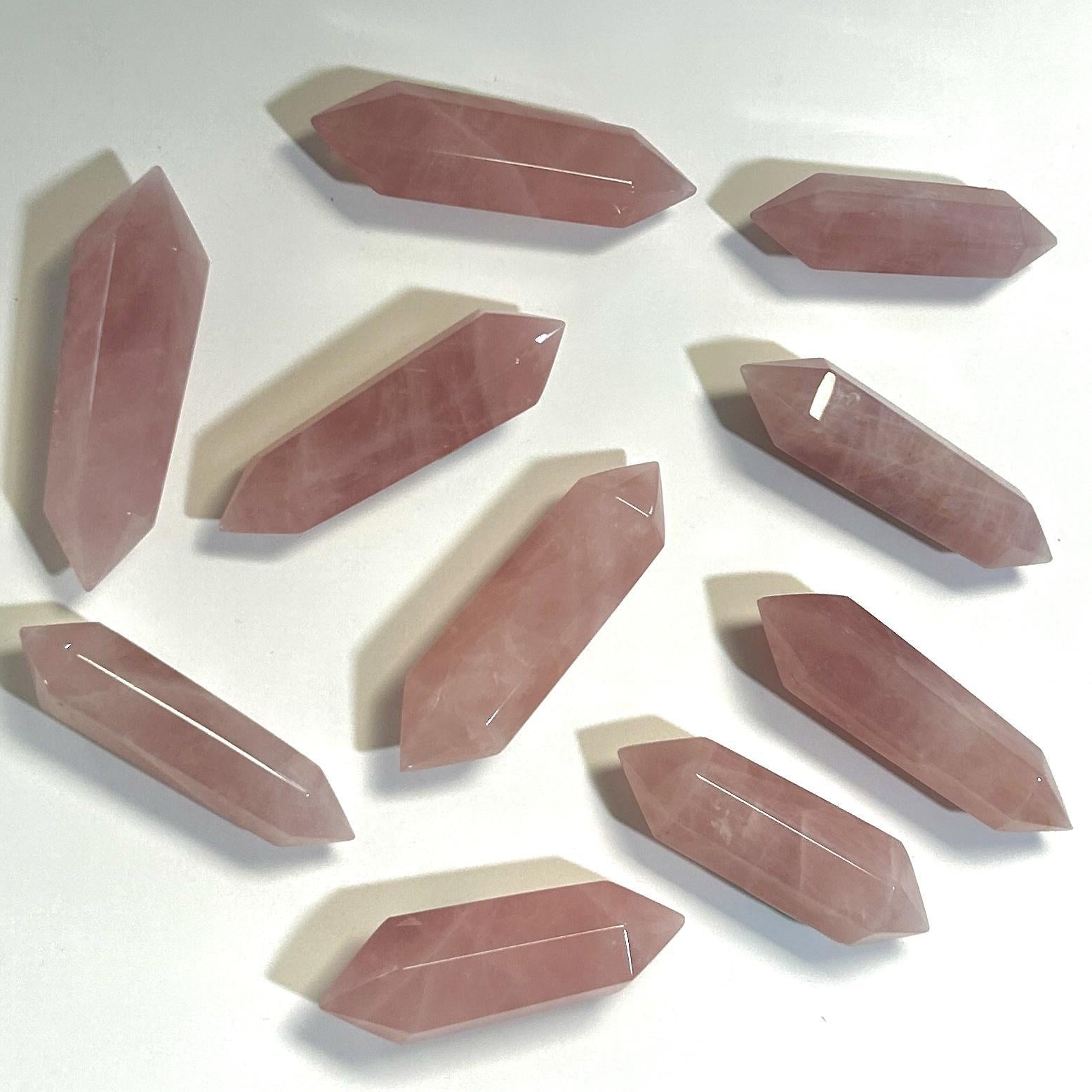 Ten Spellcrafter Rose Quartz Double Terminated Mini Towers are displayed on a white background;...